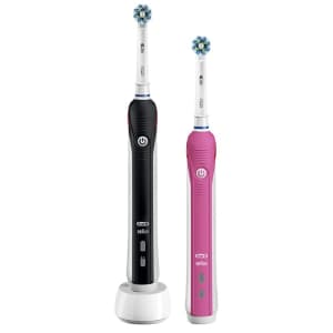 Due spazzolini elettrici Oral-b Pro 2 2950, uno nero e bianco e l'altro rosa e bianco su sfondo bianco